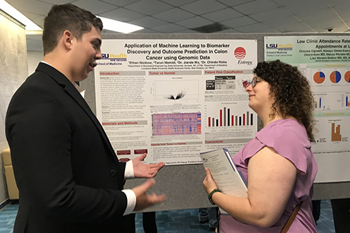 student discussing research at Summer Research Internship Program poster session